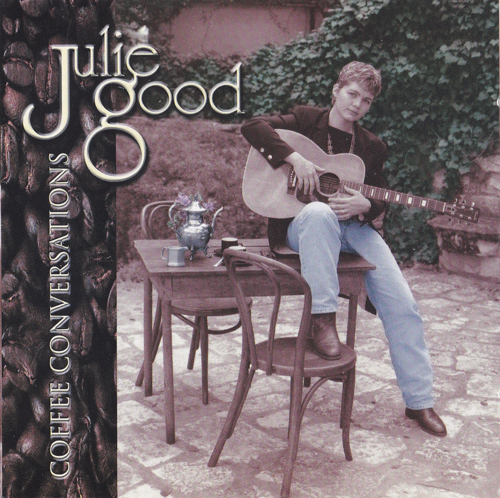 The original front cover of Coffee Conversations by Julie Good, showing the artist seated with an acoustic guitar.